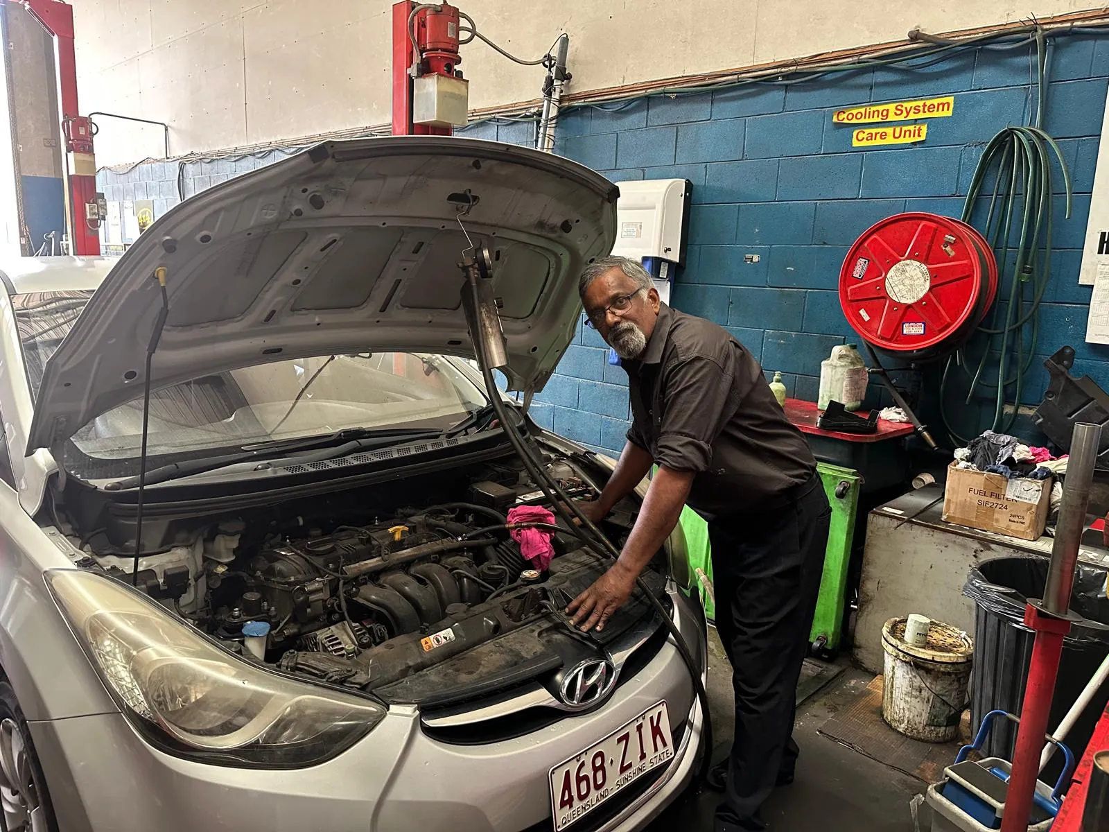 Sri working under the bonnet of a customer's car